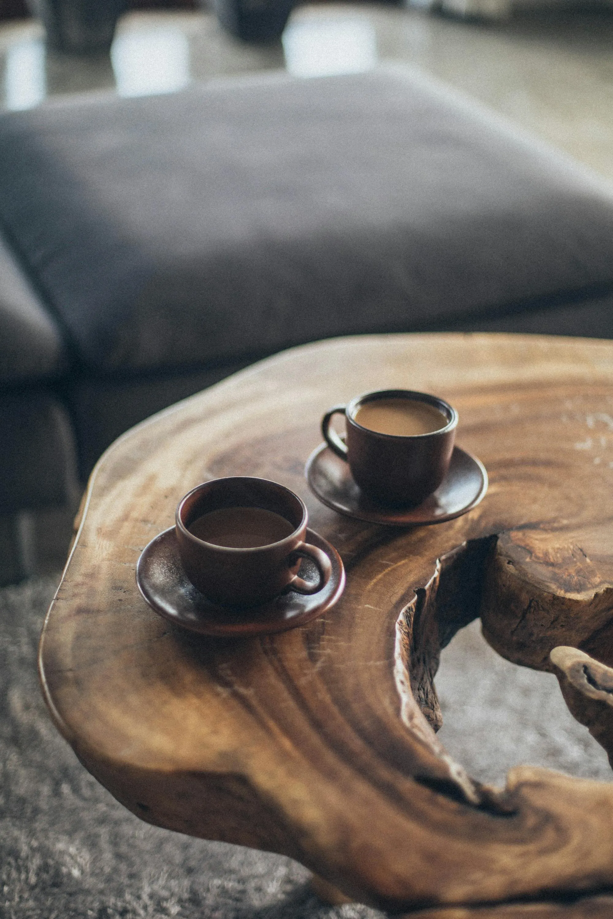 A warm cup of coffee on a windowsill in soft morning light